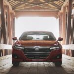 A red 2021 Honda Accord is shown parked on a bridge after viewing a used Honda Accord for sale.