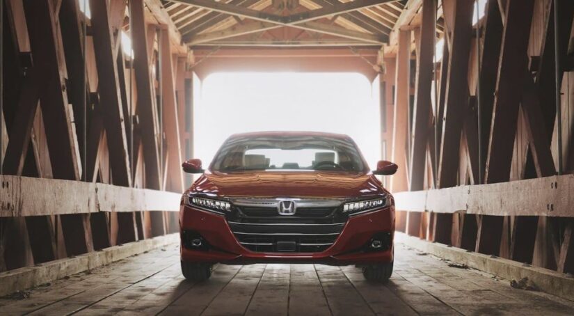 A red 2021 Honda Accord is shown parked on a bridge after viewing a used Honda Accord for sale.