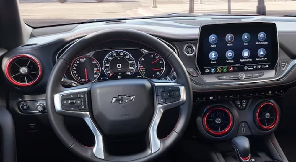 The black and red interior and dash of a 2024 Chevy Blazer is shown at a Chevy dealer.