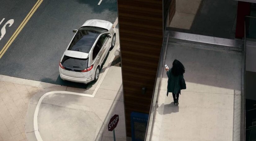 A white 2024 Ford Edge SE is shown parked on a curb as seen from above.