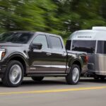 A black 2024 Ford F-150 Platinum is shown towing a trailer.