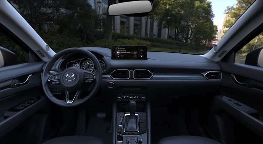 The black interior and dash of a 2024 Mazda CX-5 is shown.