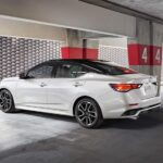 A white 2024 Nissan Sentra is shown parked in a parking garage.