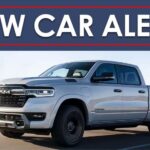 A New Car Alert banner is shown above a silver 2025 Ram 1500 Ramcharger.