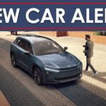 A New Car Alert banner is shown above a parked blue 2025 Toyota Crown Insignia.