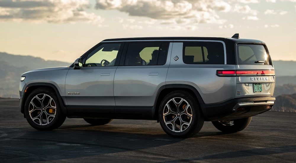 A silver 2023 Rivian R1S is shown parked on a cloudy day.