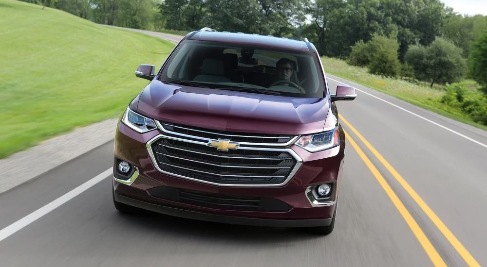 A purple 2018 Chevy Traverse is shown driving on a highway.