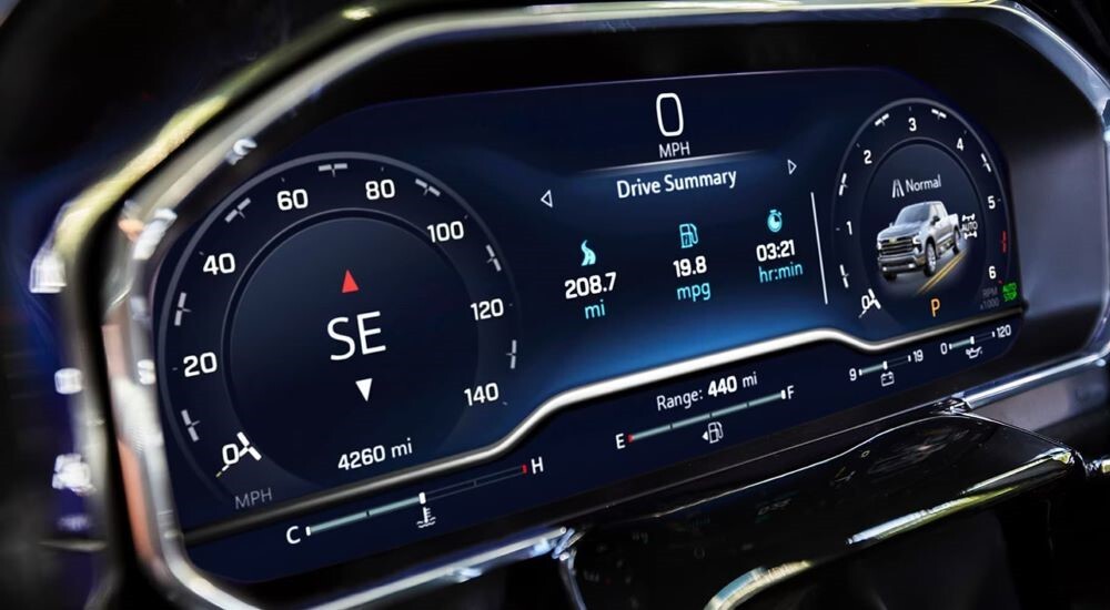 The summary screen of a 2023 Chevy Silverado 1500 is shown, featuring the gauges, fuel, and mileage information.