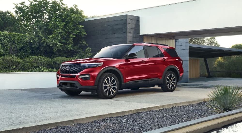 A red 2023 Ford Explorer ST Line is shown parked in a driveway.