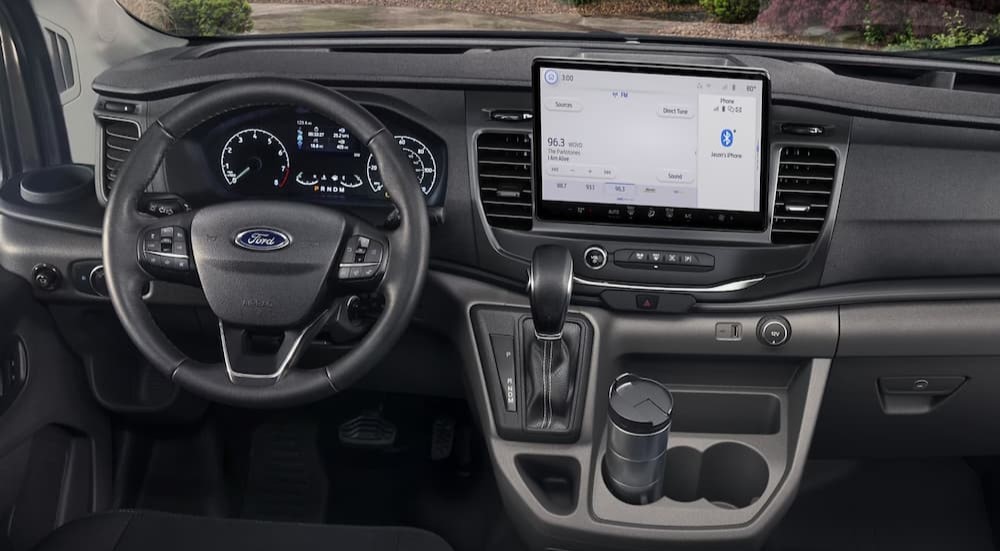 The gray interior and dash of a 2023 Ford Transit is shown.
