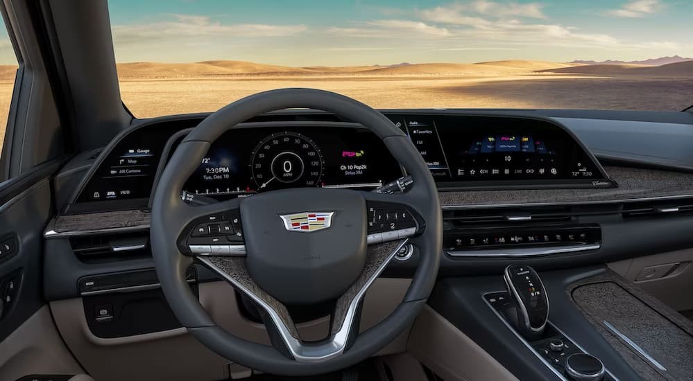 The gray and brown interior and dash of a 2024 Cadillac Escalade is shown.