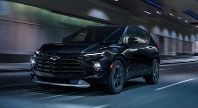 A black 2024 Chevy Blazer Midnight Edition is shown driving in a tunnel.