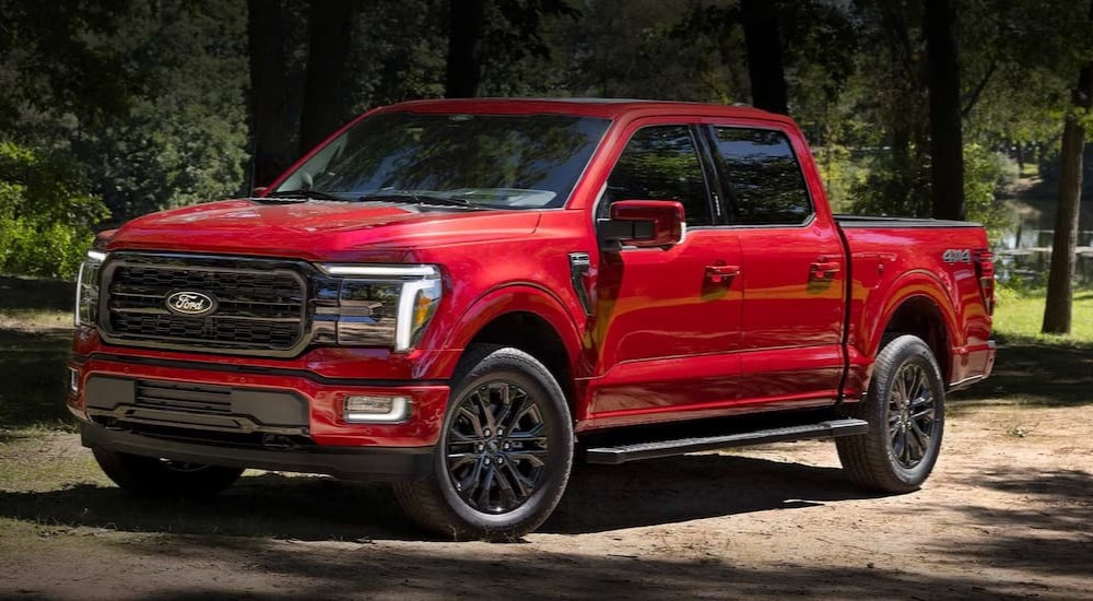 A red 2024 Ford F-150 is shown parked off-road.
