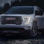 A silver 2024 GMC Acadia AT4 is shown parked off-road after visiting a GMC dealer near Lynchburg.