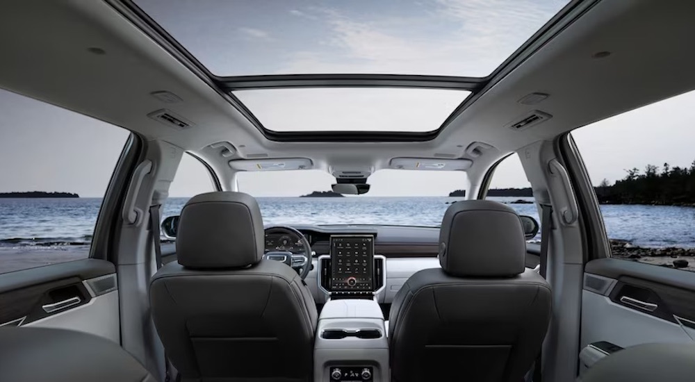 The grey interior of a 2024 GMC Acadia Denali is shown from behind.