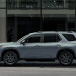 A light gray 2024 Honda Pilot Trailsport is shown near a building.