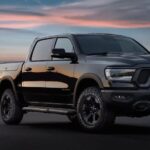 A black 2024 Ram 1500 for sale is shown parked at night.