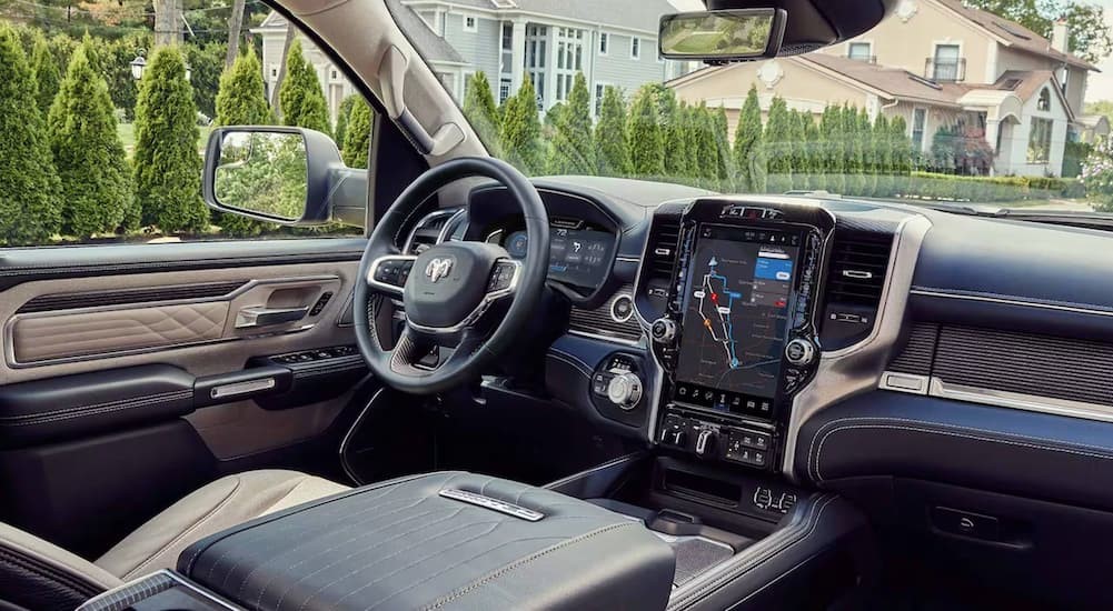 The black and cream interior and dash of a 2024 Ram 1500 Limited is shown.
