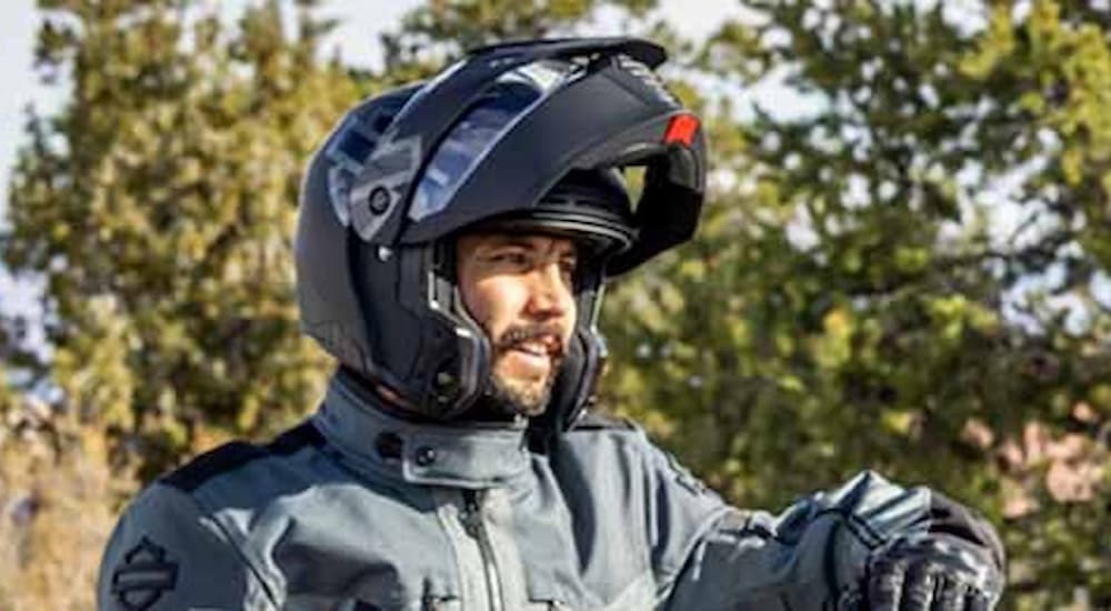A person is shown wearing a modular helmet.