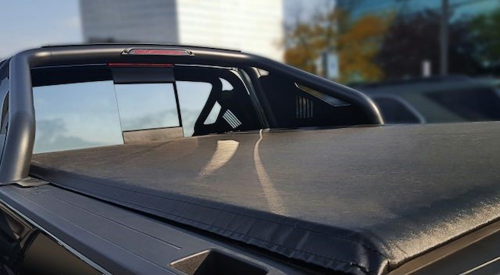 A soft roll-up Tonneau cover is shown being used on the bed of a Chevy truck.