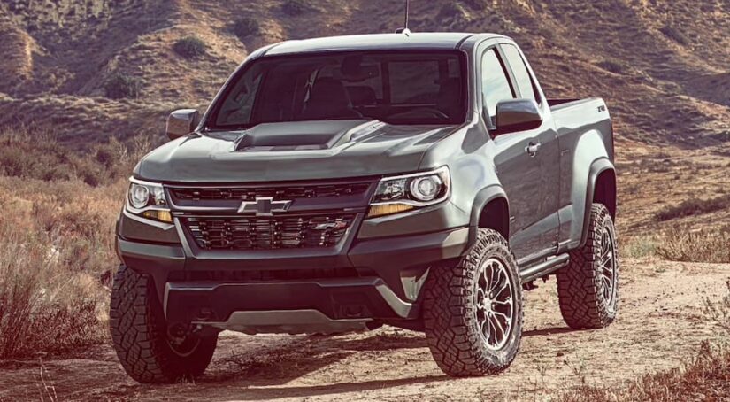 A grey 2020 Chevy Colorado ZR2 for sale is shown driving off-road.