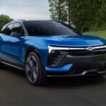 A blue 2024 Chevy Blazer is shown driving after visiting a Chevy dealer near Livonia.