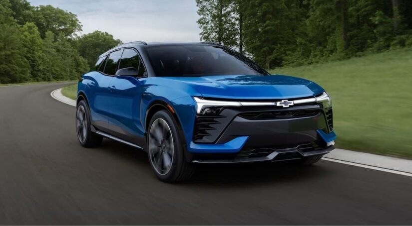 A blue 2024 Chevy Blazer is shown driving after visiting a Chevy dealer near Livonia.