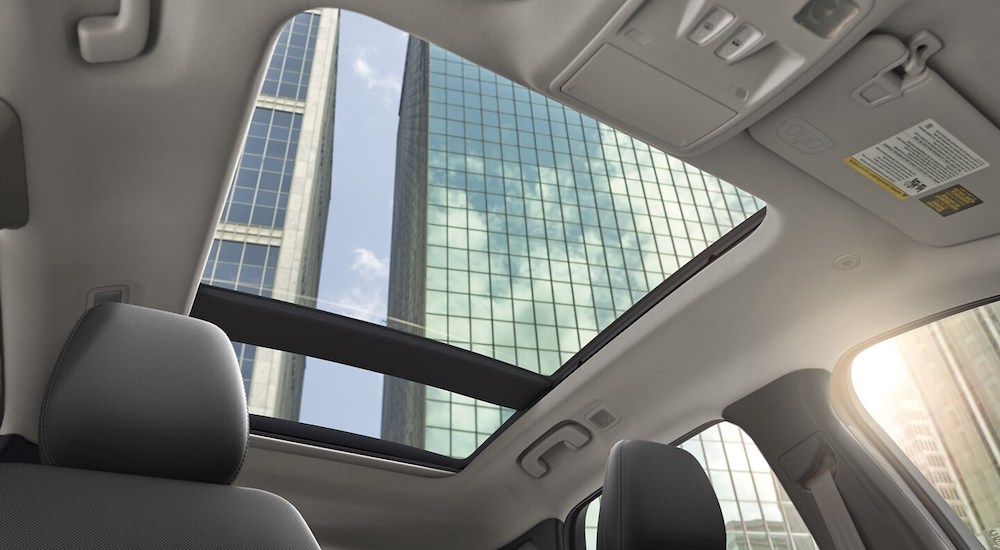 A sunroof is shown from the grey interior of a 2024 Ford Escape Platinum