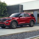A red 2024 Ford Explorer ST is shown parked near a house.