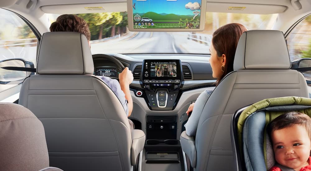 A family using the infotainment screens during a roadtrip in a 2024 Honda Odyssey.