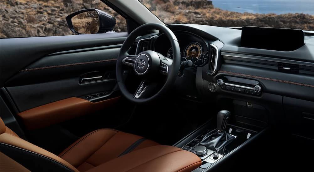 The black interior of a 2024 Mazda CX-50 is shown.