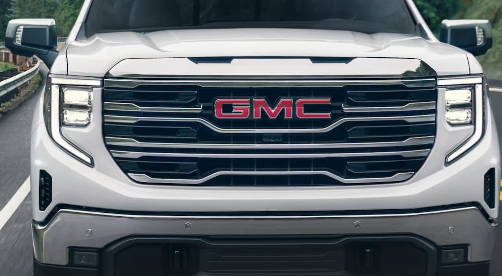Close up of the front of a white 2024 GMC Sierra 1500.