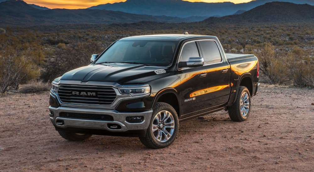 One of many popular used trucks, a 2019 Ram 1500, is shown parked off-road.