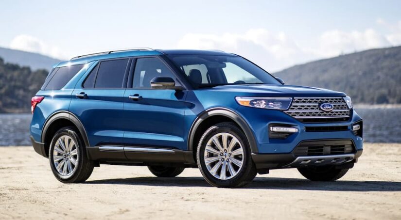A blue 2021 Ford Explorer is shown parked off-road after visiting a used Ford dealership.