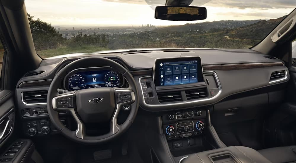 The gray interior and dash of a 2024 Chevy Tahoe is shown.