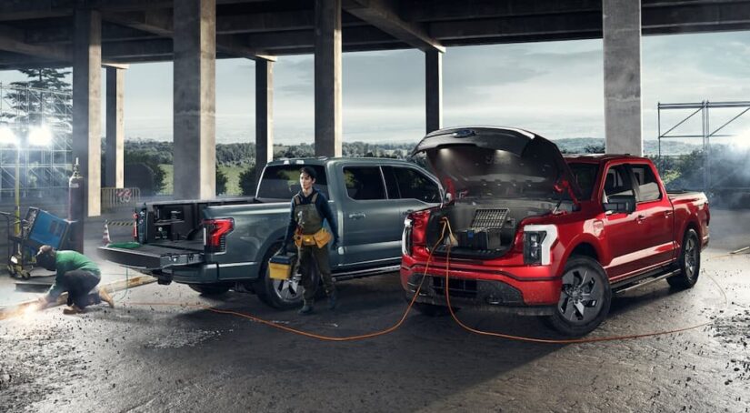 Two 2024 Ford F-150 Lightnings being used to power tools at a job site.