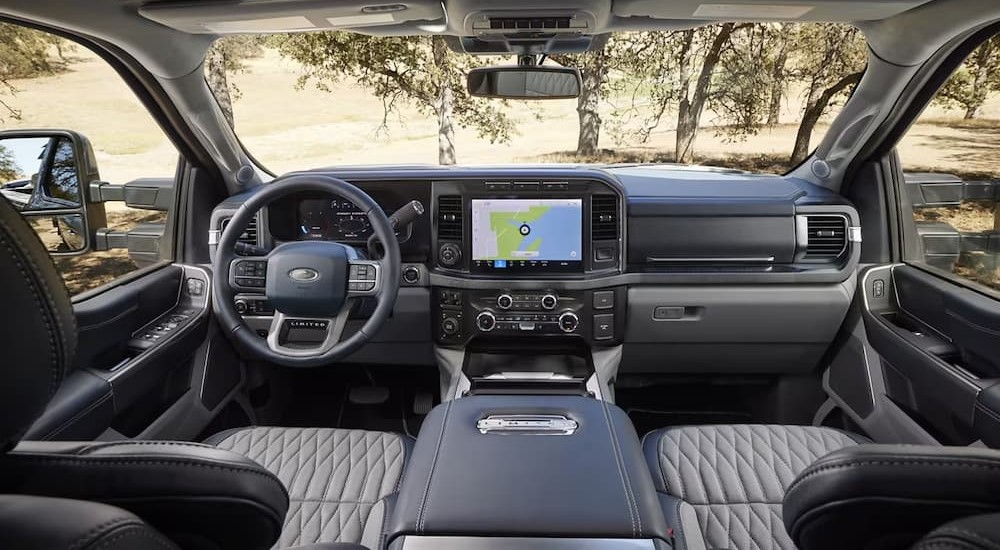 The gray interior and dash of a 2024 Ford F-250 Limited is shown.