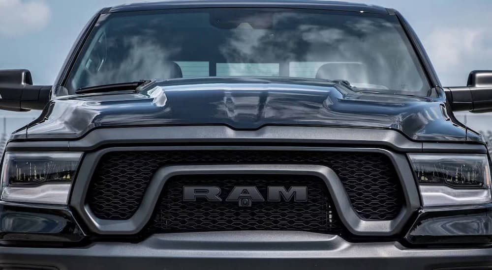 A close-up of the grille on a black 2024 Ram 1500 Classic is shown.