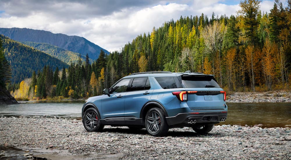 A blue 2025 Ford Explorer ST is shown from the rear at an angle.