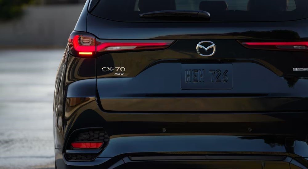 A close up shows the rear of a black 2025 Mazda CX-70.