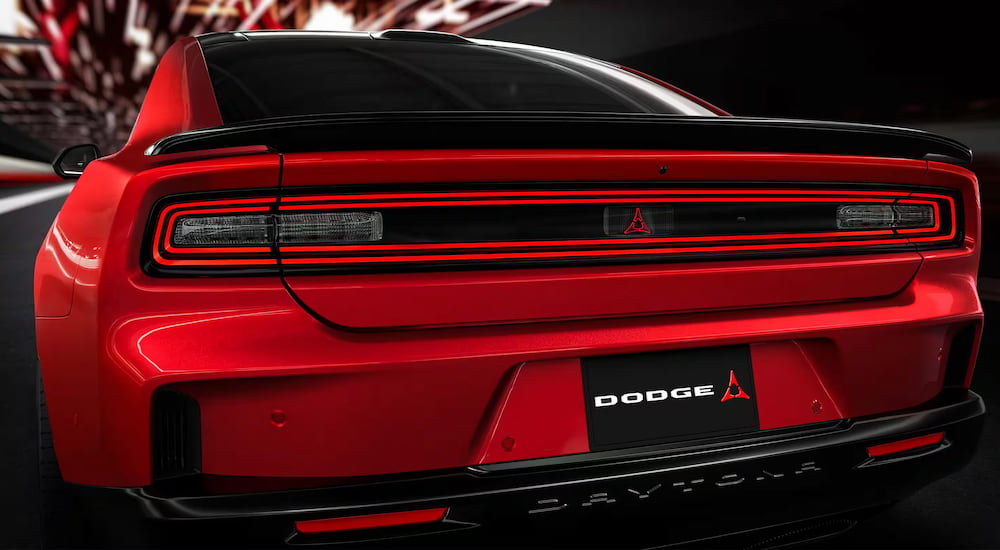 A red 2024 Dodge Charger Daytona EV is shown from the rear.