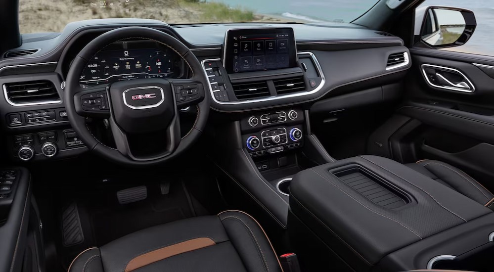 The black interior and dash in a 2024 GMC Yukon XL is shown.