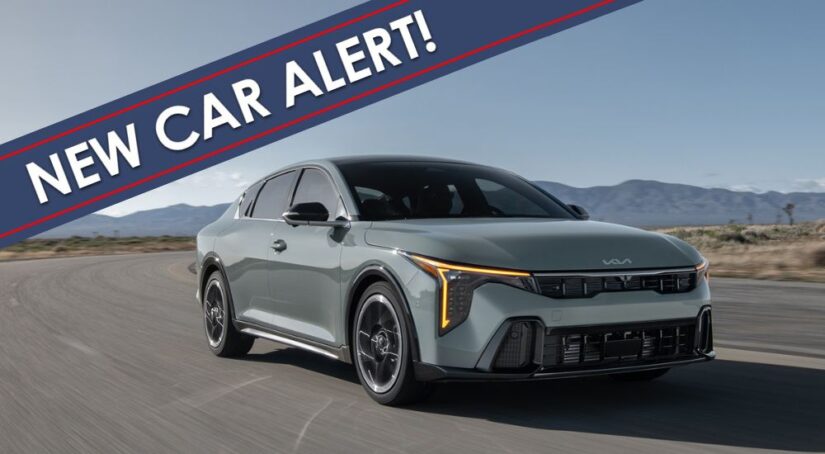 A grey 2025 Kia K4 is shown driving on an open road with a New Car Alert banner overlayed.
