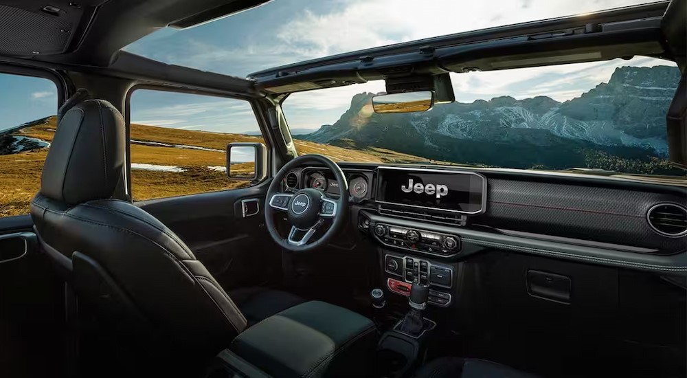 The black interior and dash in a 2024 Jeep Wrangler is shown.
