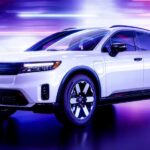 A white 2024 Honda Prologue for sale is shown displayed in a showroom.