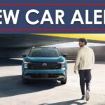 A person is shown approaching a teal 2025 Nissan Kicks SR under a new car alert banner.