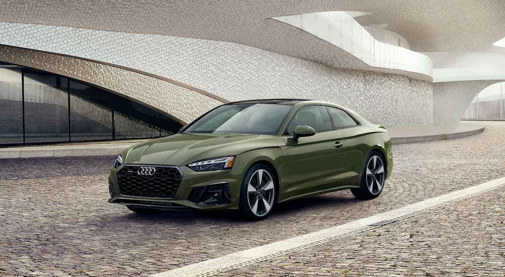 A green 2020 Audi A5 is shown parked outside a building.