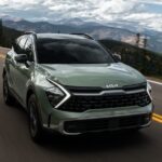 A green 2024 Kia Sportage is shown from the front at an angle.
