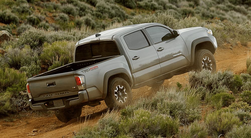 A gray 2021 Toyota Tacoma TRD is shown driving off-road.