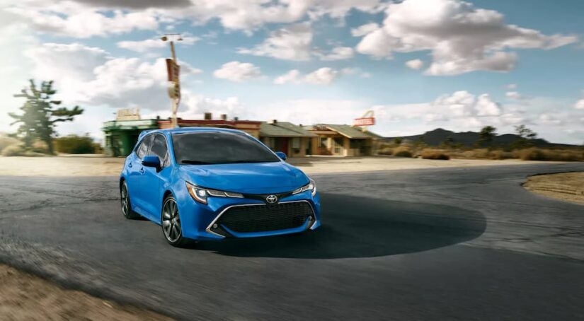 A blue 2022 Toyota Corolla is shown driving on a road after visiting a used Toyota dealer near Fair Oaks.